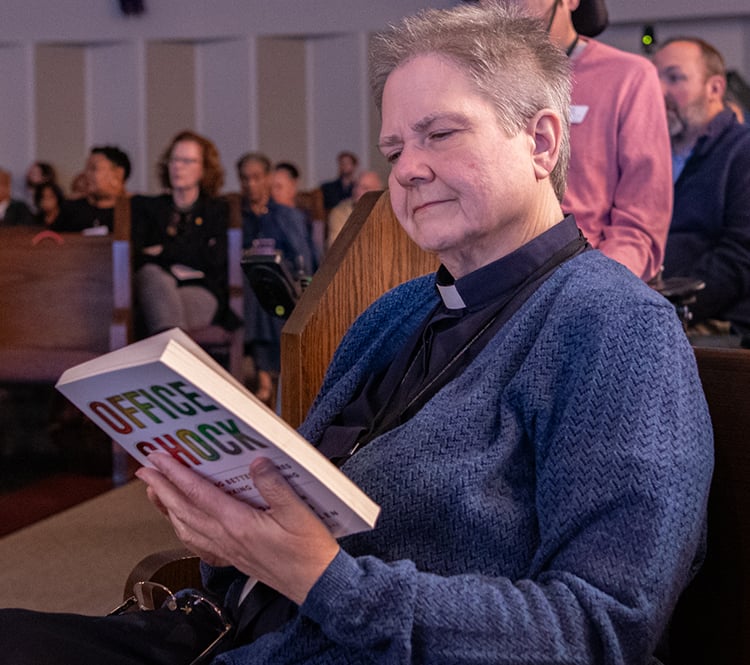 Pastor looking at Office Shock book