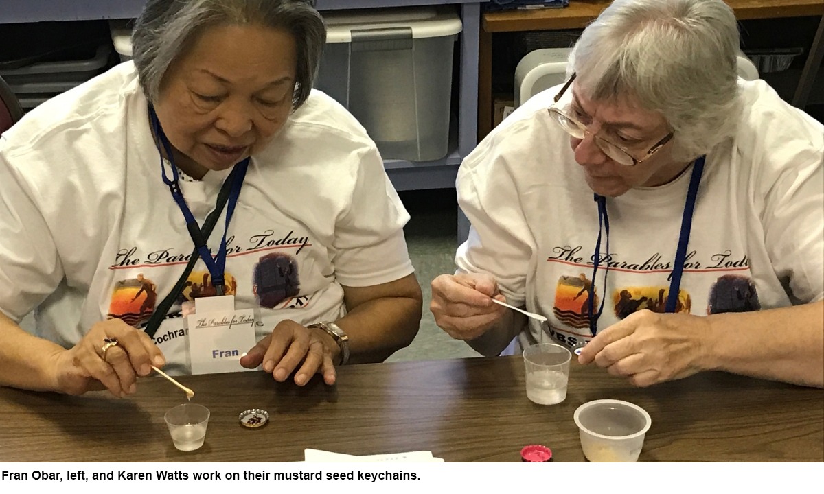 Fran Obar, left, and Karen Watts work on their mustard seed keychains