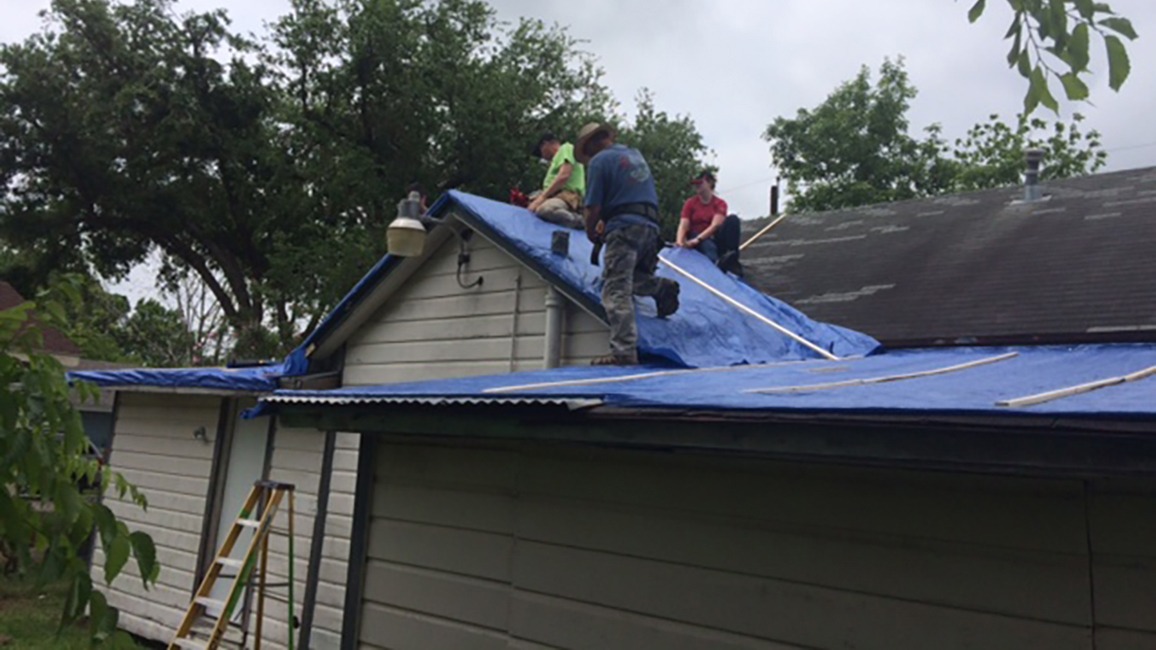 Workers fixing a roof