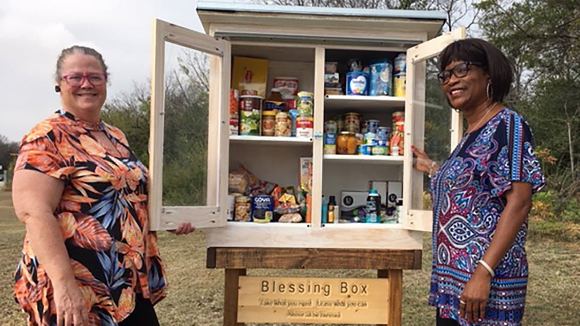 Mary Marquez and Rev. Marie Mitchell with a donation box