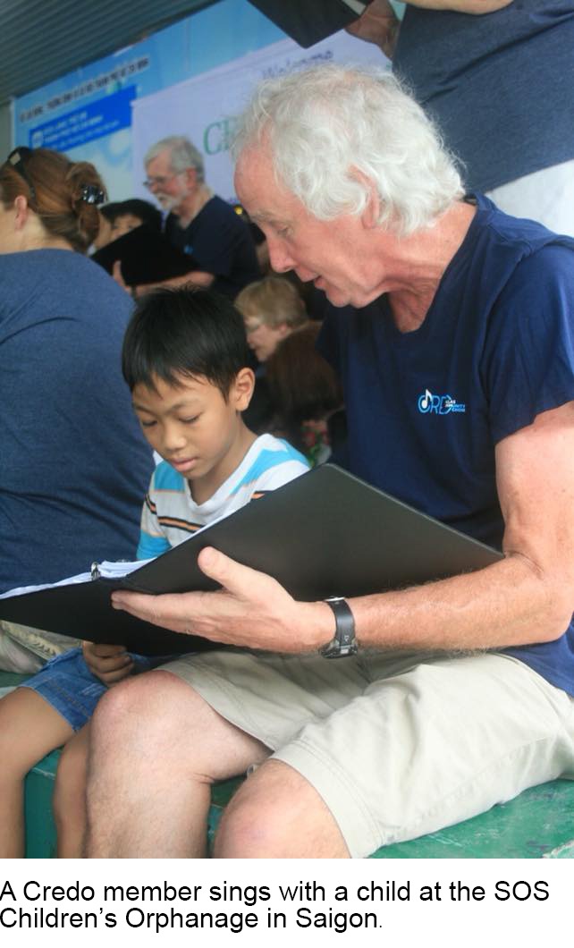 Credo member and a child sing together