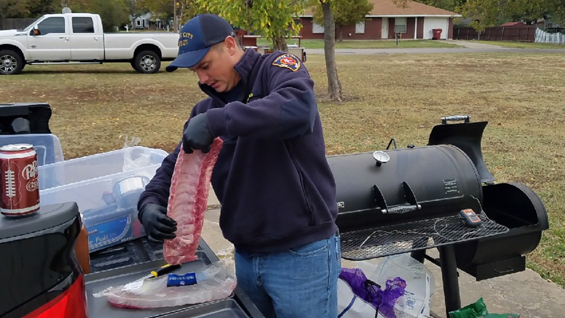 Firefighter prepares to bbq ribs