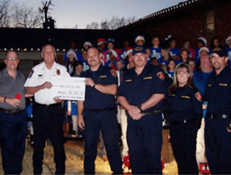 Presenting the check to firefighters
