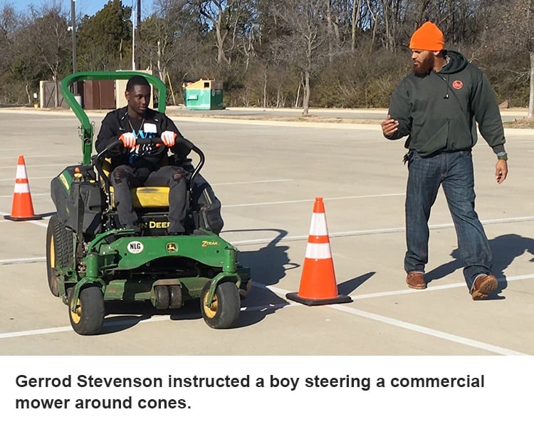 Gerrod Stevenson instructs a boy on a mower