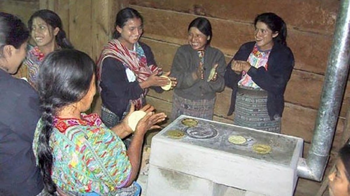 Women cooking on a stove